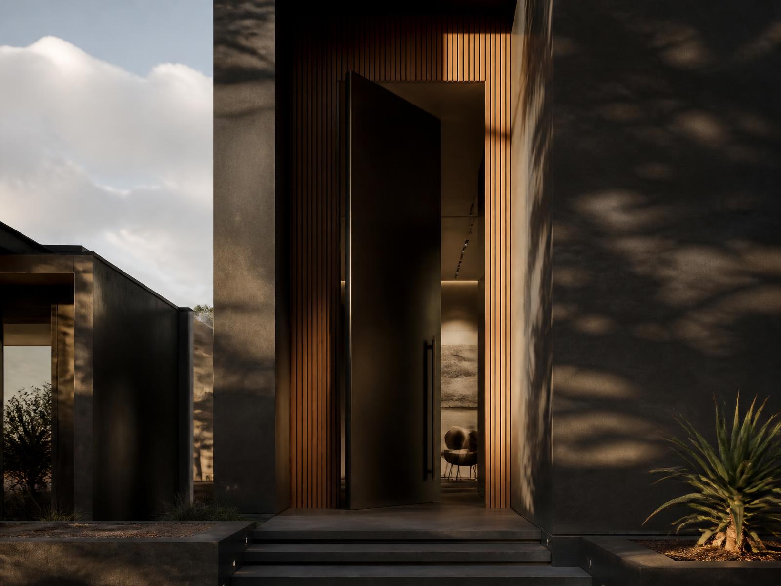 Pivot entrance door on a modern charcoal facade